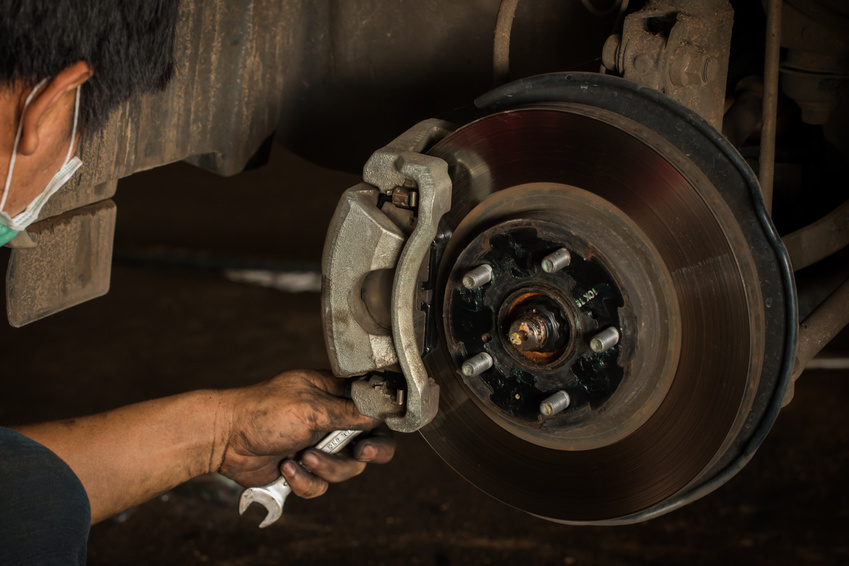 Repair Brake, Brake disk and caliper assembly on a modern car about to be replaced.