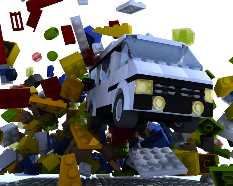 Toy van hit lego blocks on white background